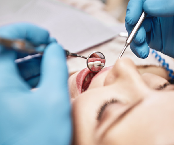Dentist looking at smiling patient's teeth