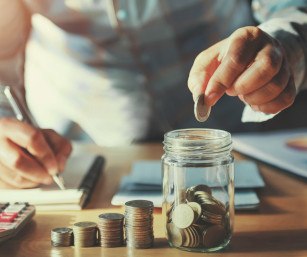 Coins going into a jar