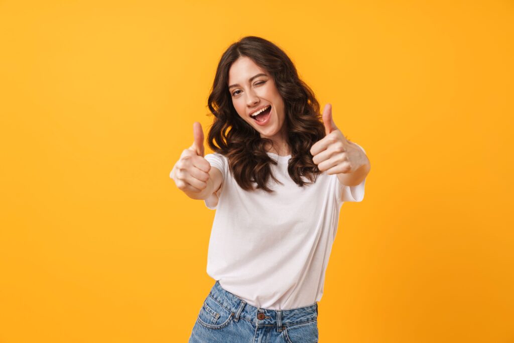 Woman in white t-shirt giving 2 thumbs up